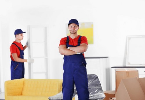 Professional movers unloading items with caution