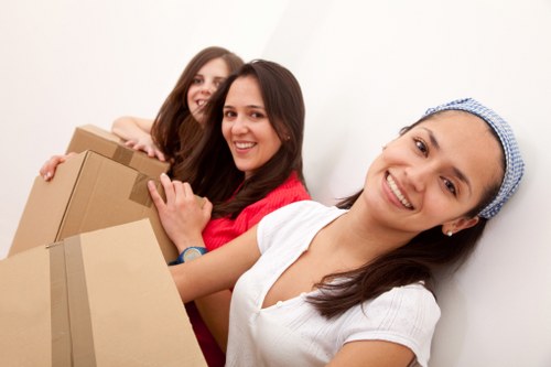Packed moving boxes and protected furniture in a Chelsea property
