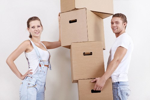 Professional movers handling furniture for a Chelsea flat relocation